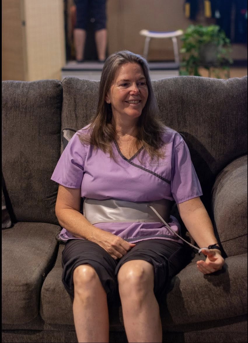 Guest relaxing with a PEMF belt during a session